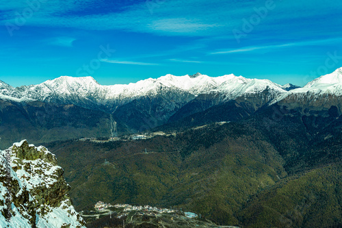 alpine landscape with peaks covered by snow and clouds