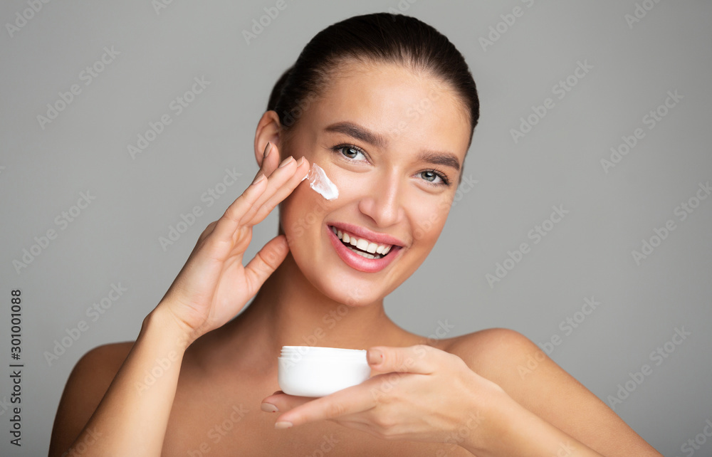 Skincare and hydrating. Girl applying face cream Skincare and hydrating. Girl applying face cream
