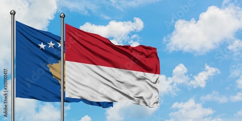 Kosovo and Indonesia flag waving in the wind against white cloudy blue sky together. Diplomacy concept, international relations.