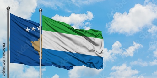 Kosovo and Sierra Leone flag waving in the wind against white cloudy blue sky together. Diplomacy concept, international relations.