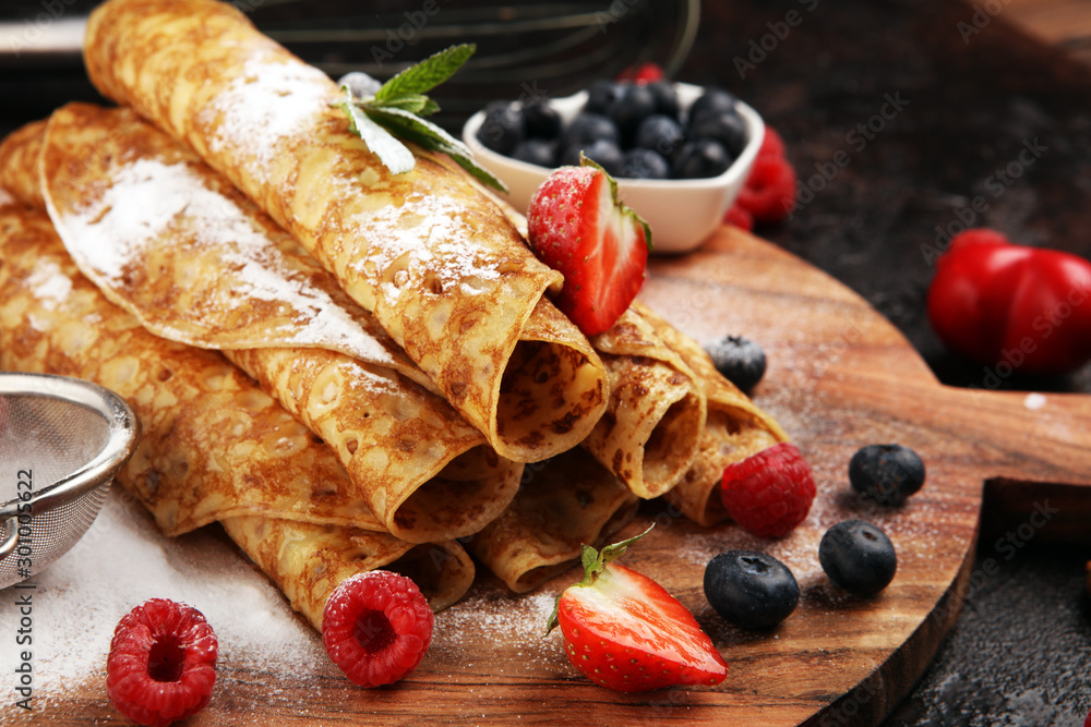 Delicious Tasty Homemade crepes or pancakes with raspberries and mint on rustic background - obrazy, fototapety, plakaty 