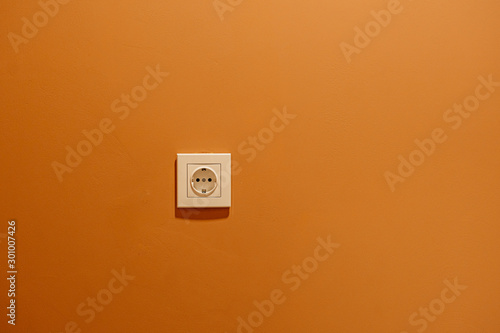 white rosette on orange wall