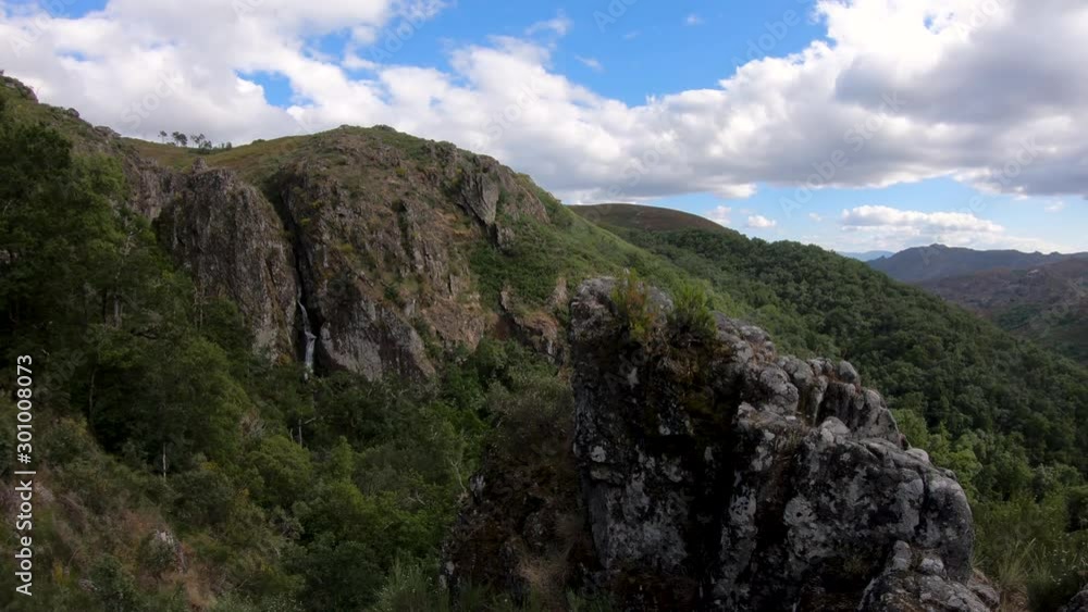 View of the waterfall near the traditional village of Pitoes das Junias at the Peneda Geres National Park, Portugal View of the waterfall near the traditional village of Pitoes das Junias at the Peneda Geres National Park, Portugal