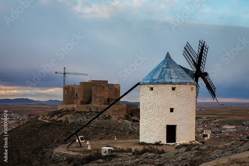 Traditional windmill and medieval castle in Consuegra. Spain.