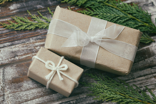 Set of parcel wrapped in craft paper and tie hemp cord. Delivery service. Online shipping. Decorative wooden background. Christmas presents concept. Many gifts. а © exienator