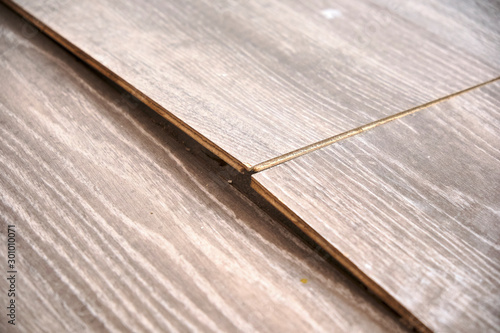 Damaged parquet floor. Bending planks because of expansion due to humidity and moist.