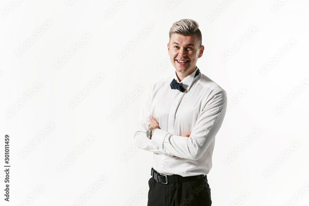 Portrait of young smiling handsome showman in white shirt with bowtie, studio shot isolated on white background. Businessman Portrait of young smiling handsome showman in white shirt with bowtie, studio shot isolated on white background. Businessman