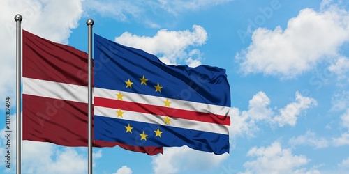 Latvia and Cape Verde flag waving in the wind against white cloudy blue sky together. Diplomacy concept, international relations.