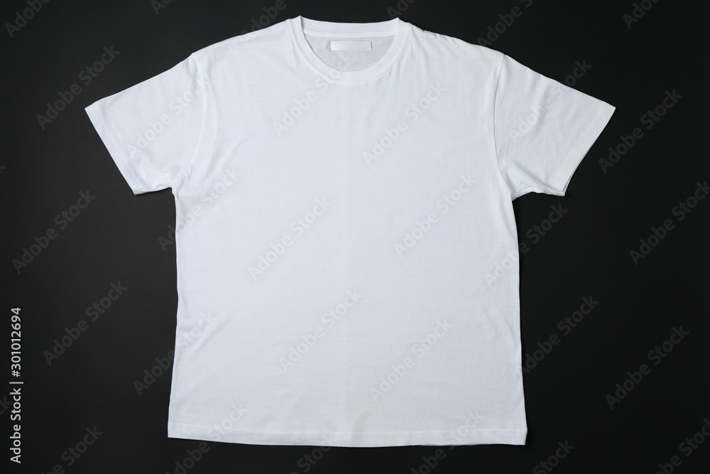 Blank white t-shirt on black background, space for text Blank white t-shirt on black background, space for text