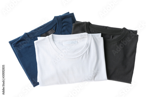 Folded multicolored t-shirts isolated on white background, space for text