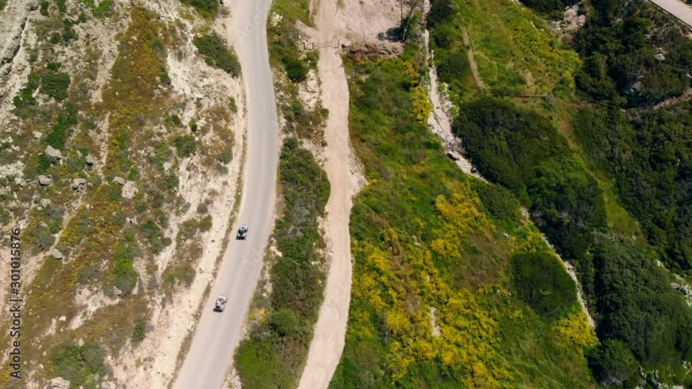 Top view down two ATVs riding mountain road, Cyprus Top view down two ATVs riding mountain road, Cyprus