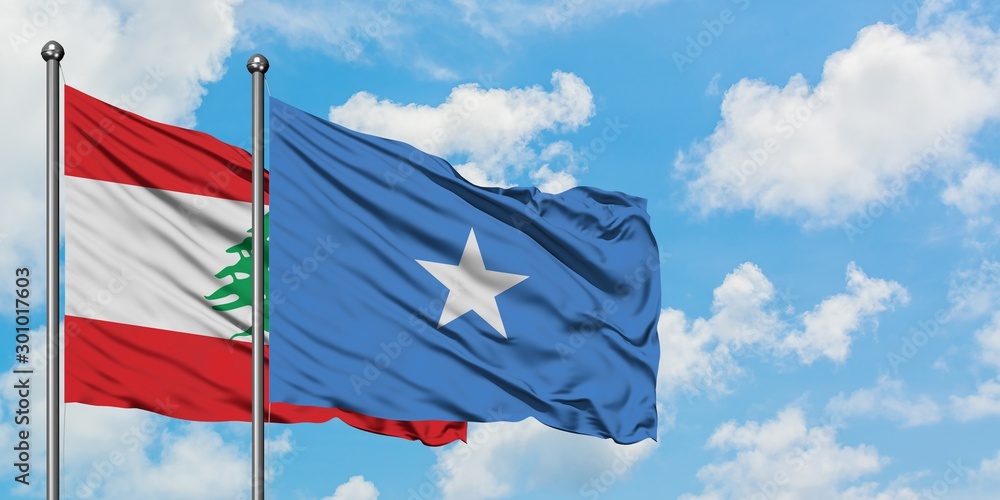 Fototapeta premium Lebanon and Somalia flag waving in the wind against white cloudy blue sky together. Diplomacy concept, international relations.