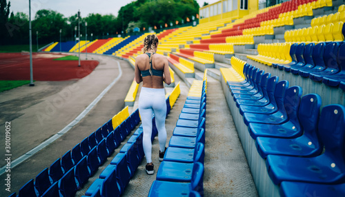 Braided fit woman walking in stadium
