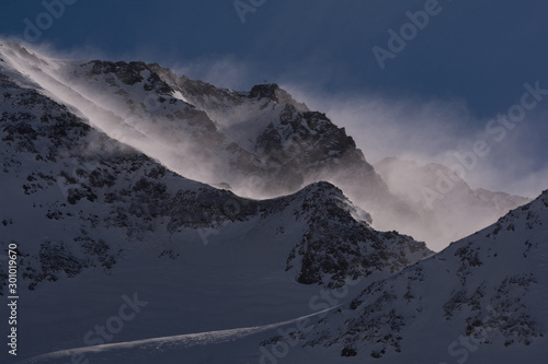 Blizzard in the high mountains. Fog, light, blizzard, mountain crests in minimal shot.View over the Alps, from Kaunertal Glacier area, in Tyrol, Austria.