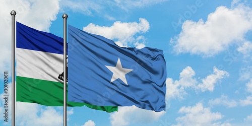 Lesotho and Somalia flag waving in the wind against white cloudy blue sky together. Diplomacy concept, international relations.