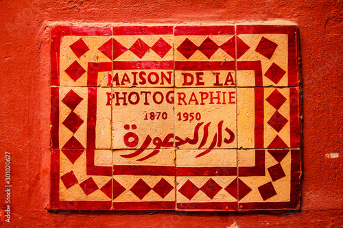 sign on a colored wall of the maison de la photographie in marrakech, morocco photo