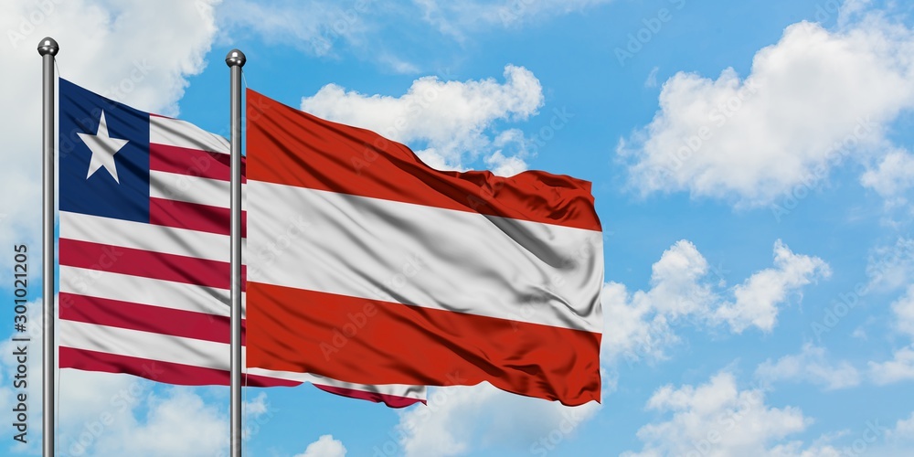 Liberia and Austria flag waving in the wind against white cloudy blue sky together. Diplomacy concept, international relations.