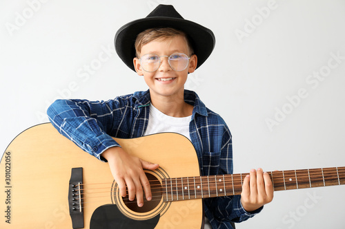 Little boy playing guitar o...