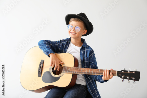 Little boy playing guitar o...