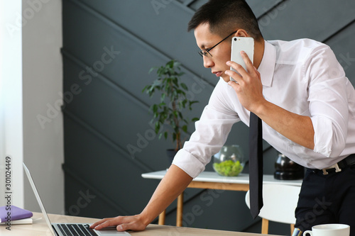 Asian businessman talking b...