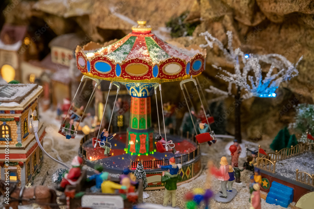Amusement park in miniature with carousels in winter