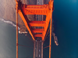 Aerial top view of Golden Gate Bridge with highway, metropolitan transportation infrastructure, birds eye view of automobiles and car vehicles moving on road of suspension construction
