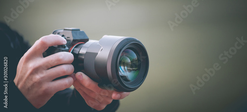 Man taking picture with photo camera, modern technology, close-up