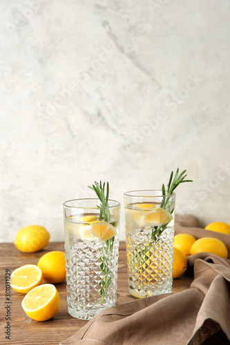 Glasses of fresh lemonade on table