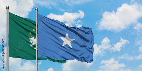 Macao and Somalia flag waving in the wind against white cloudy blue sky together. Diplomacy concept, international relations.