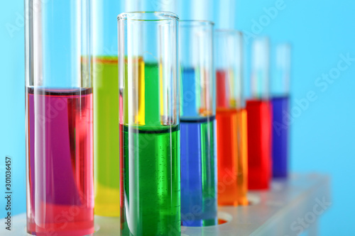 Test tubes with samples on color background, closeup