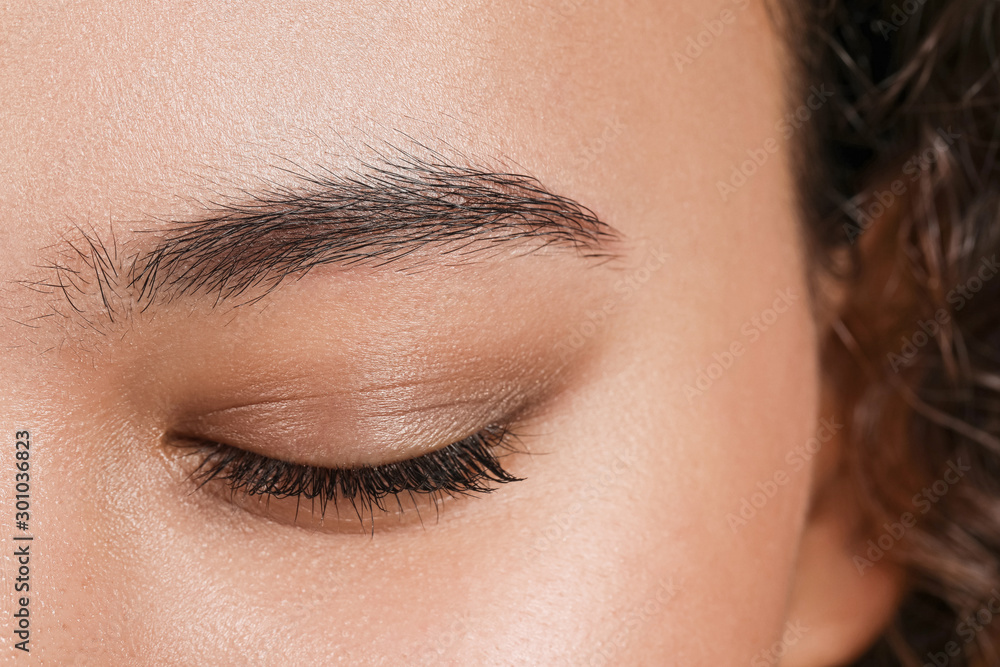 Young woman with beautiful eyebrows, closeup