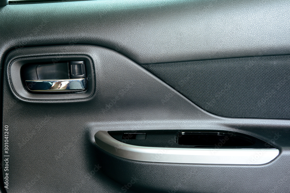 the latch panel of the right door and the mirror adjustment button in a car