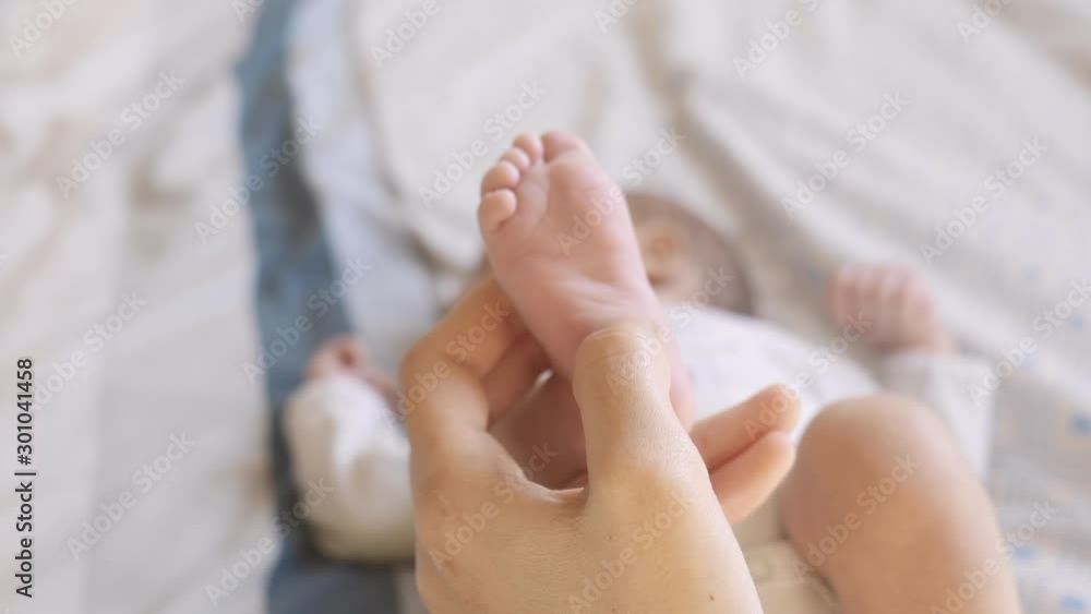 Mother Caresses the Feet of her Newborn Baby In Maternity 5 Mother Caresses the Feet of her Newborn Baby In Maternity 5