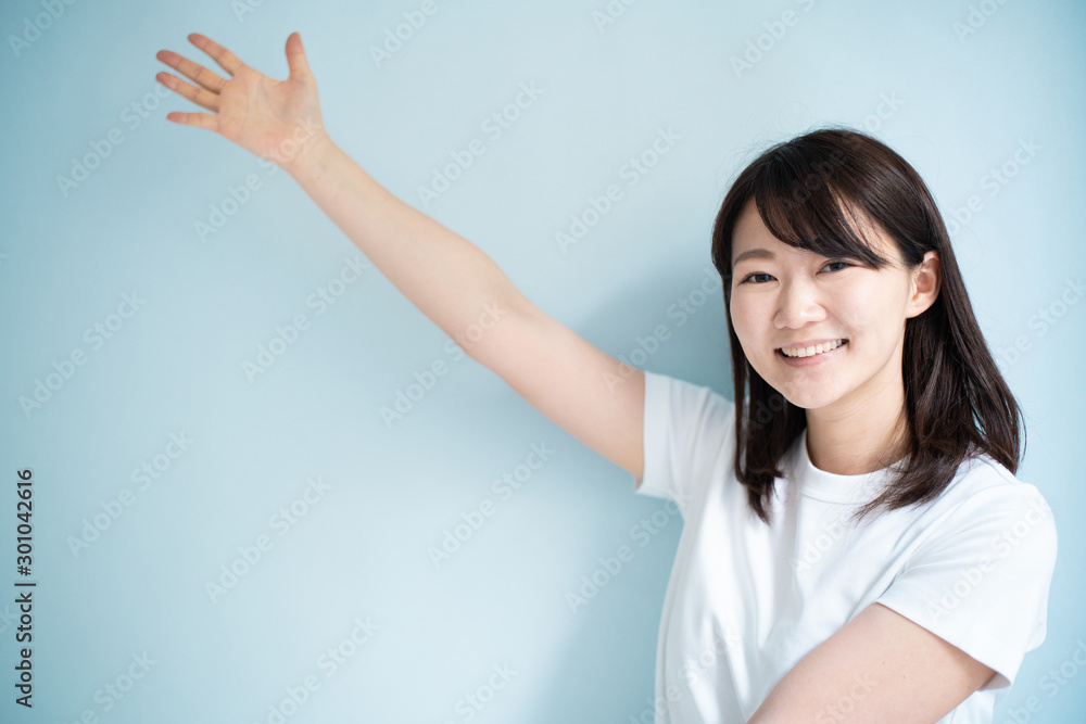 Young woman explaining against light blue background Young woman explaining against light blue background