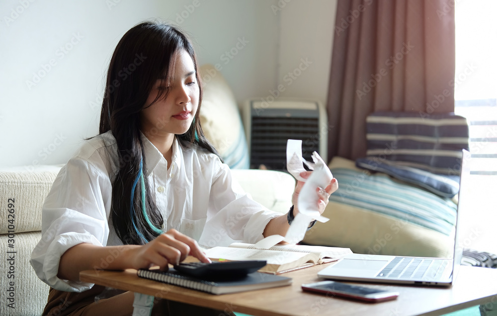 Business working in home living room enjoying sunny morning on the day with documents and laptop people Consulting and business planning. Business working in home living room enjoying sunny morning on the day with documents and laptop people Consulting and business planning.
