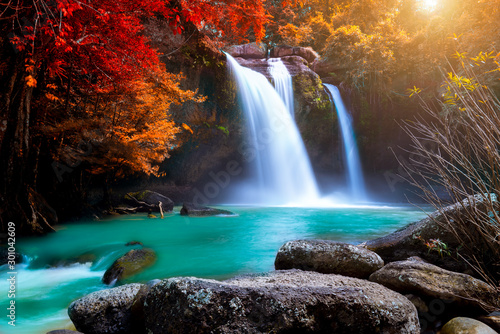 Fototapeta Naklejka Na Ścianę i Meble -  The amazing colorful waterfall in autumn forest blue water and colorful rain forest.