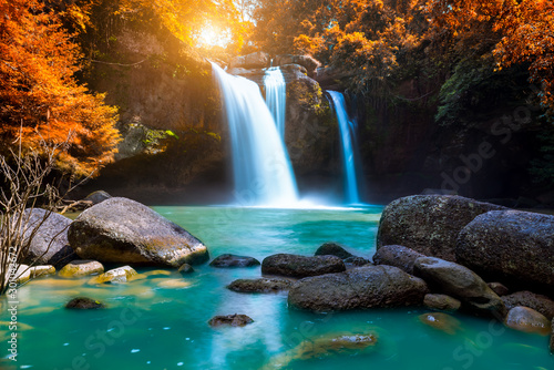 The amazing colorful waterfall in autumn forest blue water and colorful rain forest.