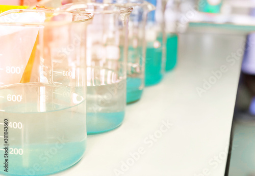 Waste water sample in beakers coagulation and flocculation method with Copper Sulfate and using Jar test for forming precipitation and reduced turbidity calibration range. Use for science background.