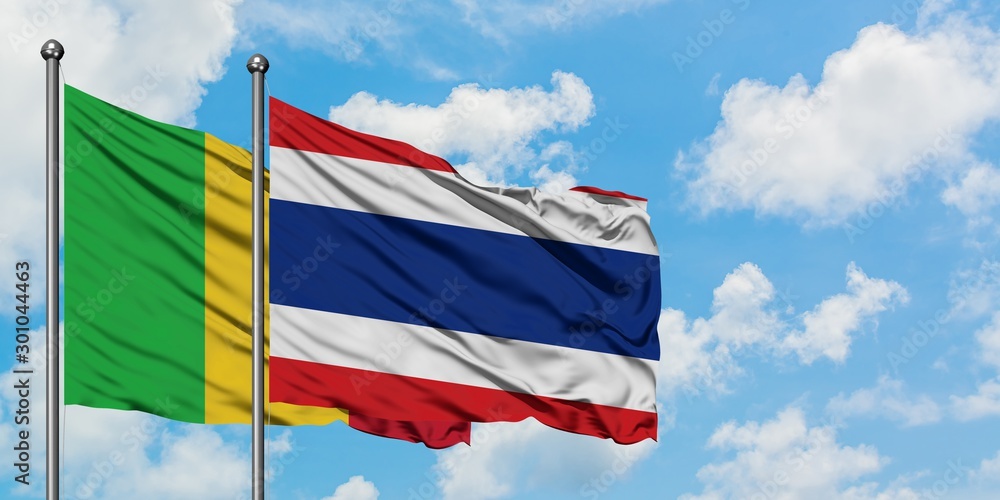 Mali and Thailand flag waving in the wind against white cloudy blue sky together. Diplomacy concept, international relations.