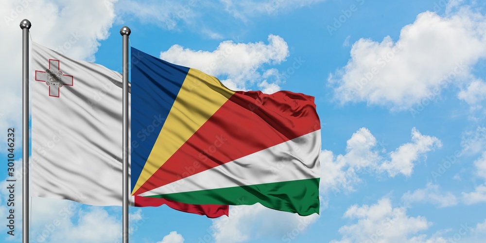 Malta and Seychelles flag waving in the wind against white cloudy blue sky together. Diplomacy concept, international relations.