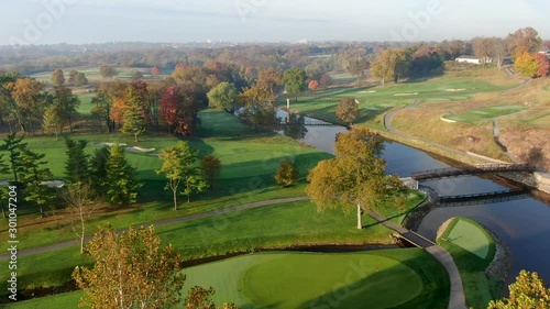 Aerial of bridges crossing Conestoga River at Lancaster Country Club, autumn leaves on trees photo