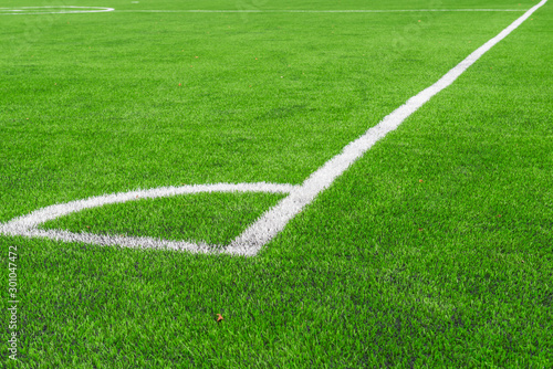 White line of  Artificial grass soccer field corner soccer field.It made to look like natural grass. It is most often used in arenas for sports that were originally or are normally played on grass.