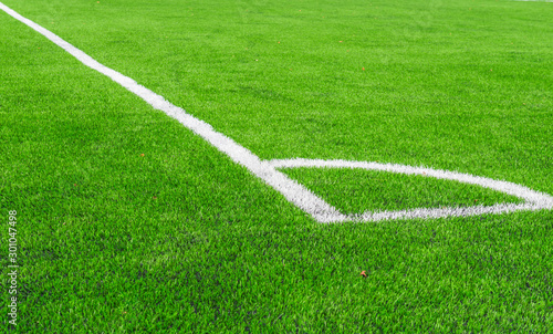 White line of  Artificial grass soccer field,corner soccer field.It made to look like natural grass. It is most often used in arenas for sports that were originally or are normally played on grass. © pomchathong007