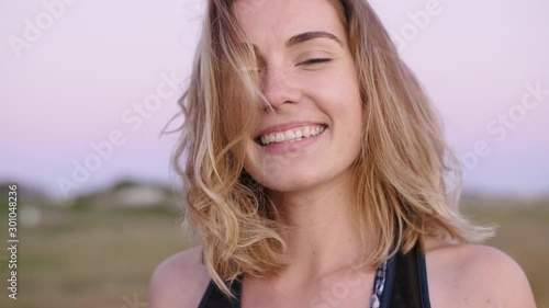 Portrait of girl next door smiling at camera, natural beauty no make up windswept hair