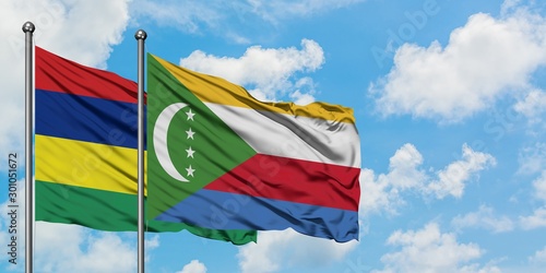 Mauritius and Comoros flag waving in the wind against white cloudy blue sky together. Diplomacy concept  international relations.