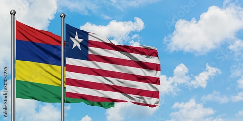 Mauritius and Liberia flag waving in the wind against white cloudy blue sky together. Diplomacy concept  international relations.