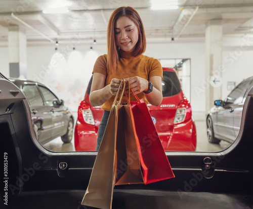 women keep shopping bags in car photo