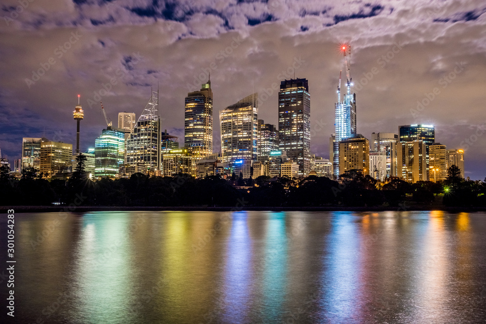 Obraz premium night cityscape with moon lit clouds