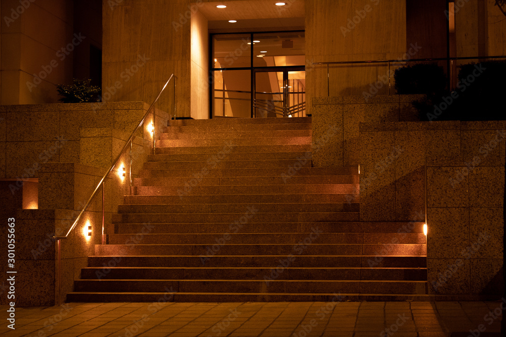 Stairs at night time on a busy street downtown wtih lights lining the walkway Stairs at night time on a busy street downtown wtih lights lining the walkway