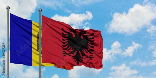 Moldova and Albania flag waving in the wind against white cloudy blue sky together. Diplomacy concept, international relations.